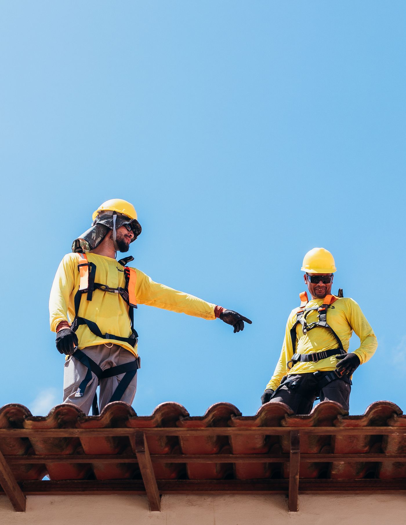 Two construction professionals reviewing roofing work on site